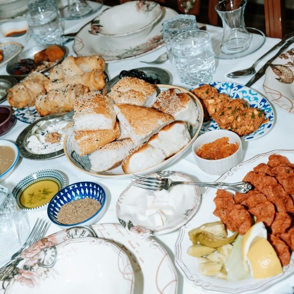 A richly set dining table with a variety of dishes, showcasing a festive meal setting.